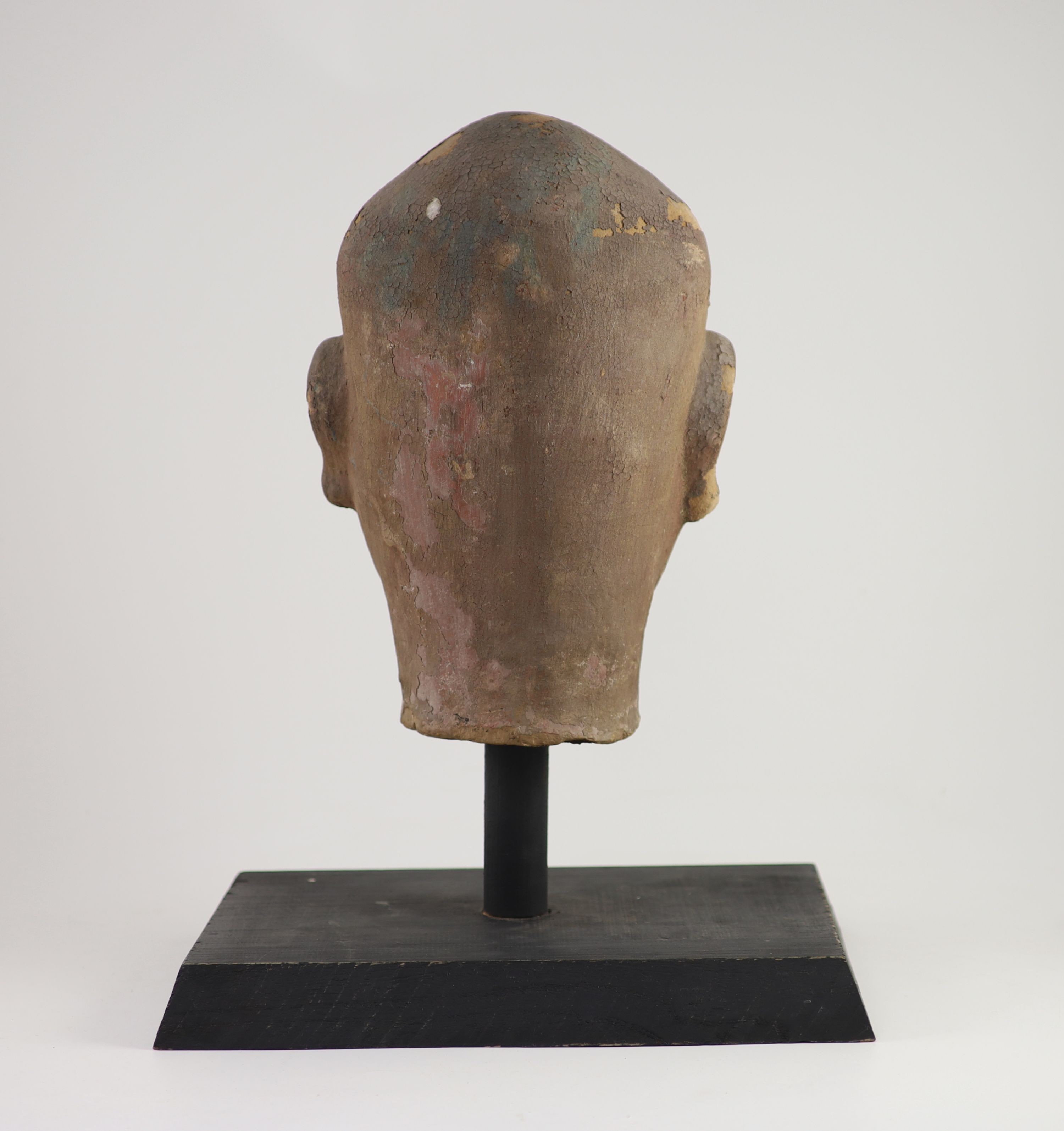 A Chinese stucco head of a luohan, Yuan-Ming dynasty, 32 cm high excluding later stand